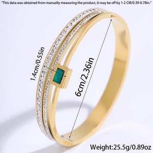 Detail shot of golden double-layer steel bracelet with emerald stone and dimensions