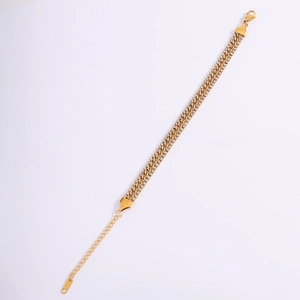 Detailed macro view of gold plated NK curb chain bracelet with sparkling zircon stones