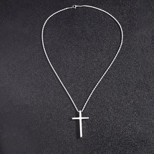 Detailed view of minimalist silver cross pendant on a finely crafted rope chain necklace