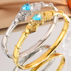 Gold and silver Claddagh bangles with blue heart crystals and diamond halo accents