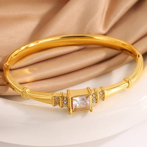 Detailed close-up of a luxury gold-plated titanium steel bracelet with a large square diamond