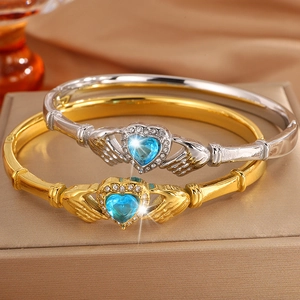 Elegant gold Claddagh bracelet with a blue heart stone surrounded by white cubic zirconia