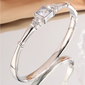 Detail of silver titanium steel bracelet featuring a large square-cut zirconia center stone