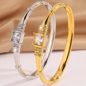 Luxurious titanium steel bangles in gold and silver with a large square diamond centerpiece