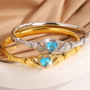 Elegant Claddagh bangles in gold and silver with heart blue stones and pavé diamonds