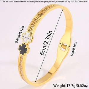 Detail view of gold clover bangle with zircon stones and hinge closure specifications