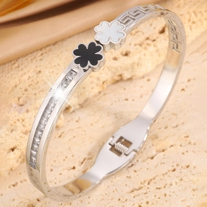 Detail of silver clover bangle with shell inlay and Greek meander engraved pattern