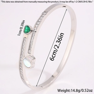 Detailed view of silver titanium steel heart bracelet with green zircon and mop charms