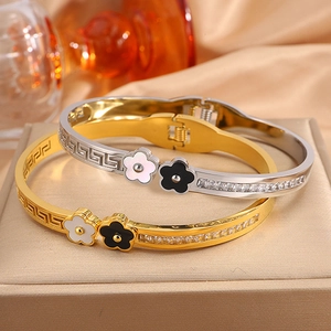 Titanium steel bangle with floral accents, Greek key pattern, and white zircon settings