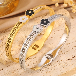 Four-leaf clover titanium steel bangle with Greek key patterns and cubic zirconia stones