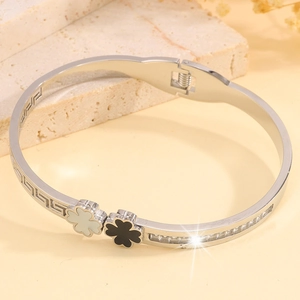 Detailed close-up of clover bangle with black-white accents and side zircon setting