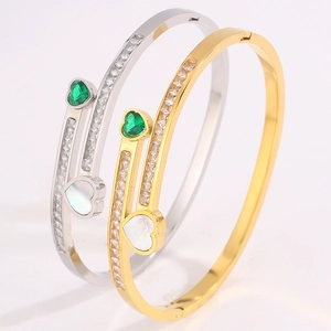 Detail of heart bracelets with emerald green stone, white shell inlay and pave cubic zirconia