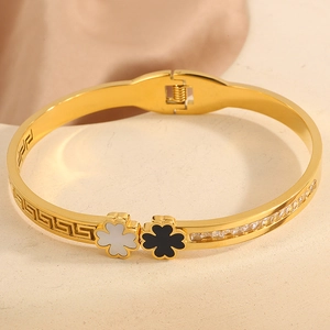 Detailed close-up of clover leaf gold bangle with mother of pearl and pave zirconia crystals
