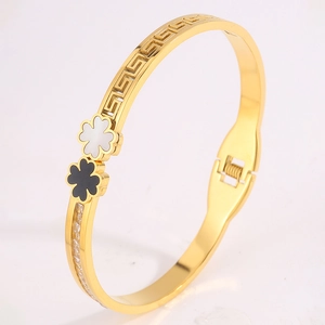 Detail of clover bangle with shell inlay, Greek key cutouts, and sparkling crystals