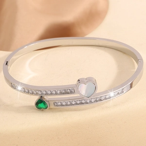 Macro shot of silver titanium heart bracelet with sparkling zircon and white shell inlay