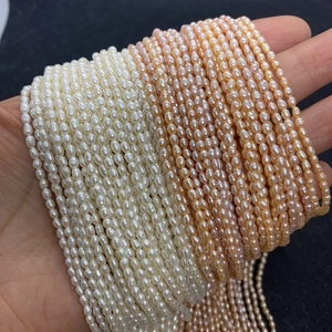 Macro detail of high luster white and pink rice-shaped freshwater pearls for jewelry