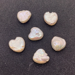 Macro shot of six irregular heart-shaped baroque pearls with natural iridescent luster