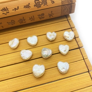 Natural heart-shaped freshwater pearls 11-12mm for DIY jewelry on bamboo background