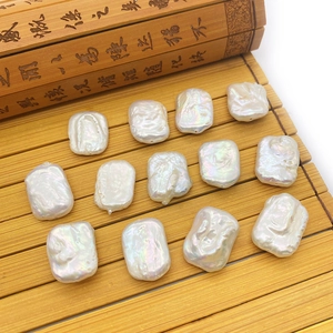 Irregular white Baroque freshwater pearls displayed on a bamboo mat for DIY jewelry