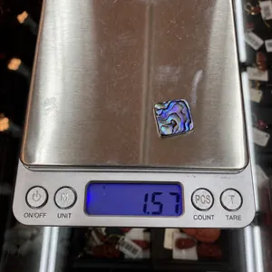 Digital scale showing a 1.57g square abalone shell inlay for jewelry making