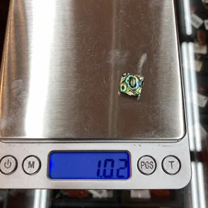 Macro scale shot showing a square natural abalone shell inlay weighing 1.02g