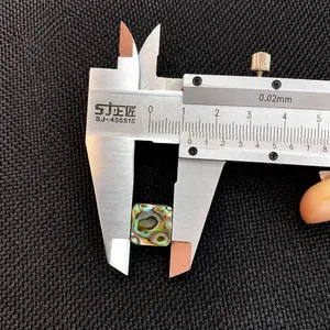 Macro shot of a 10mm square natural abalone shell inlay measured with a digital caliper