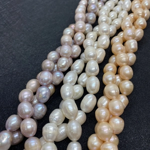Macro detail of 5-7mm natural freshwater pearls in purple, white, and orange pink tones