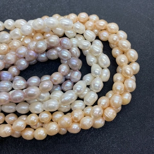 Macro shot of 5-7mm AA natural freshwater pearls in white, champagne, and lavender hues