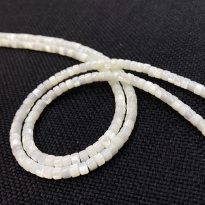 Macro detail of white square shell beads with natural iridescent luster for jewelry making