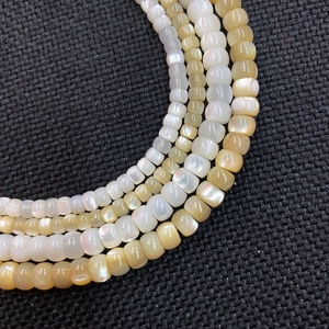 Macro shot of natural shell abacus beads for DIY jewelry necklaces with pearl luster