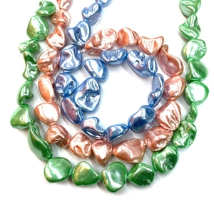 Irregular baroque shell beads in green, orange and blue with metallic luster finish