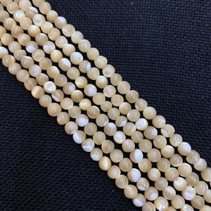 Macro shot of natural shell round beads with creamy white luster for jewelry making