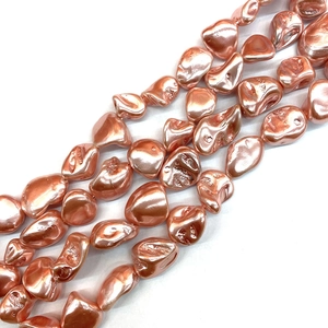 Macro shot of metallic pink irregular shell beads for DIY jewelry necklace accessories