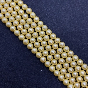 Macro shot of 8-10mm champagne gold imitation pearls with high luster for DIY jewelry