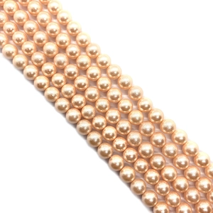 Detailed view of champagne pearl beads showing smooth glossy finish and round shape