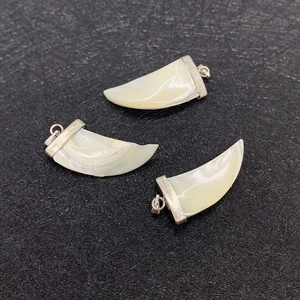 Three natural shell crescent moon pendants with shimmering ivory luster and silver clips