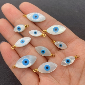 Natural sea shell evil eye charms in marquise shape with golden metal rings