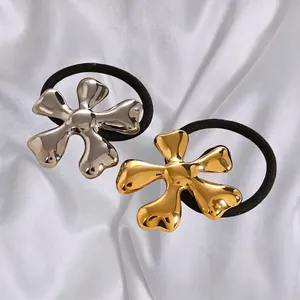 Chic stainless steel flower hair ties in gold and silver finish on silk background