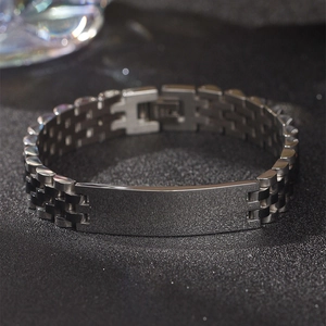 Macro view of polished silver stainless steel bracelet with watch band links and metal plate