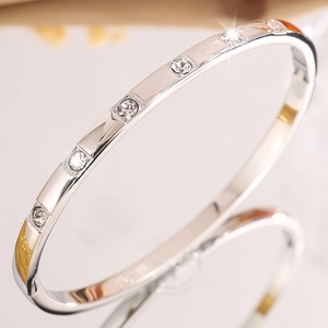 Macro shot of polished silver stainless steel bracelet with sparkling square set rhinestones