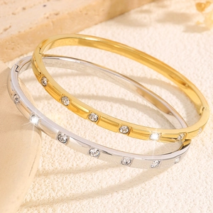 Polished titanium steel bangle set with rhinestones in gold and silver finish