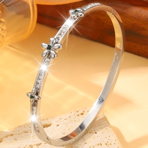 Silver stainless steel bangle with emerald green floral accents and square zircons