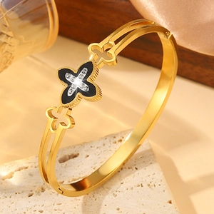 Golden titanium steel bangle featuring a hollow design and cz clover inlay for women