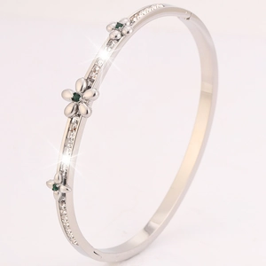 Silver stainless steel camellia flower bangle with green stones and sparkling diamonds