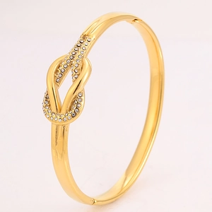 Detalle macro del brazalete de nudo en oro de 18k con pavé de cristales brillantes