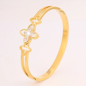 Close-up of golden clover bangle with mother of pearl inlay and sparkling crystal accents