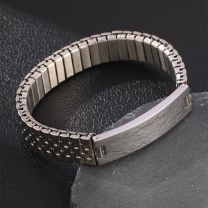 Detail of silver stainless steel watch link bracelet with brushed rectangle plate