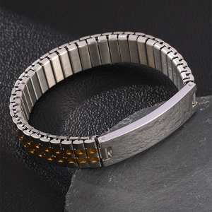 Detail macro view of two-tone stainless steel bracelet with textured engravable metal plate