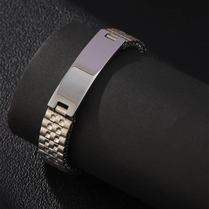Macro view of silver stainless steel men's watch chain bracelet on a black display stand
