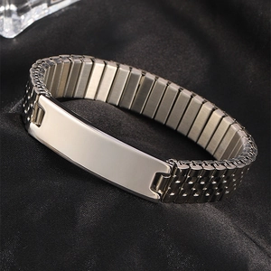 Detailed view of a silver stainless steel stretch watch band bracelet on black silk